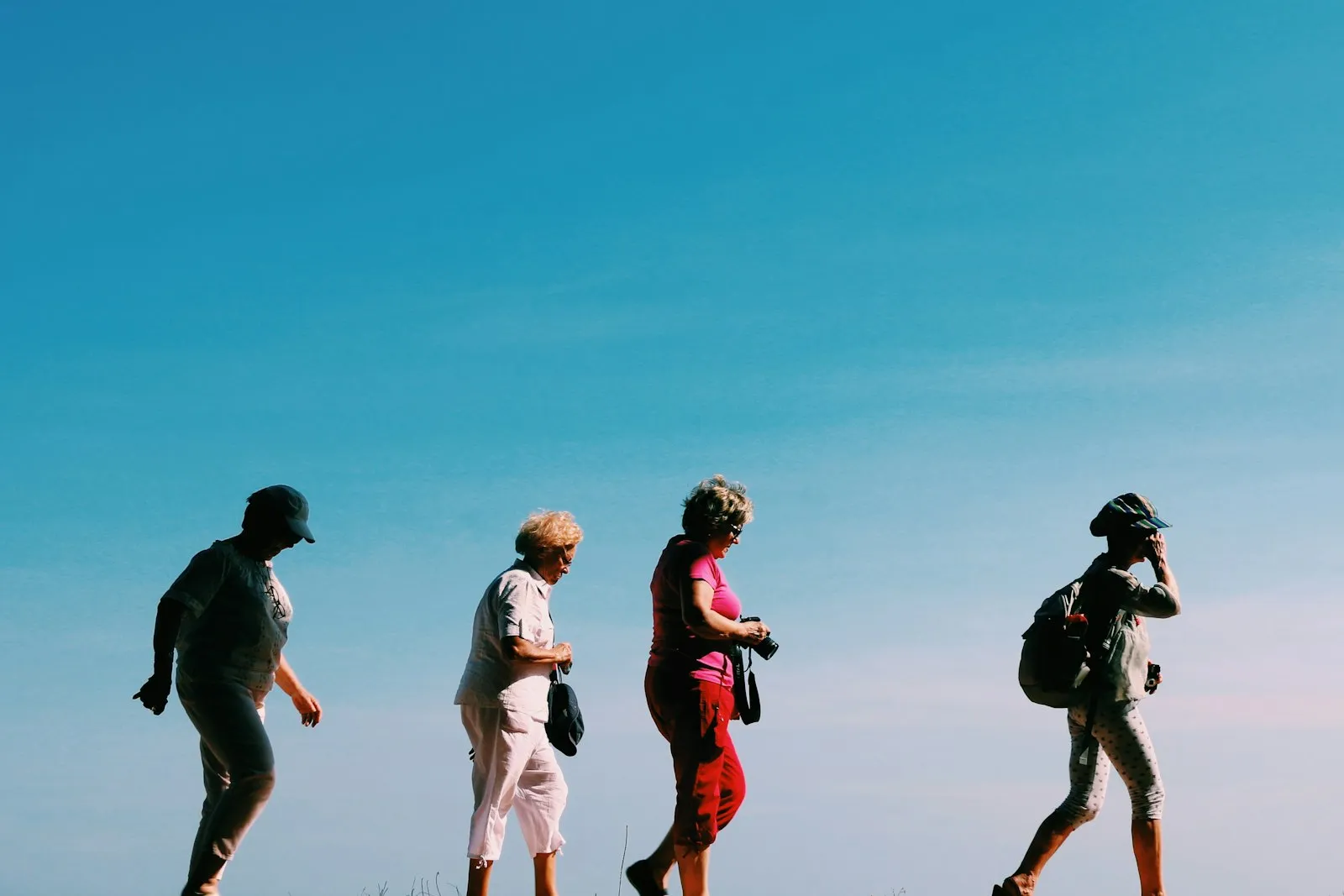 A small group of people walking together along an outdoor path
